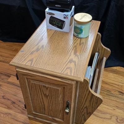 Magazine rack end table with brand new Jensen digital alarm clock and a scented candle