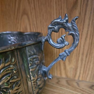 Large decorative pot metal bowl with candle and a green vase