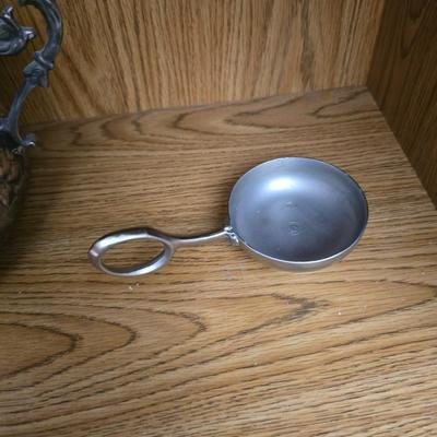 Large decorative pot metal bowl with candle and a green vase
