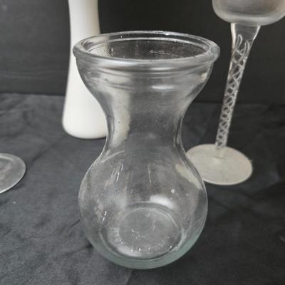 Glass vases and candle holders with boquet of faux flowers
