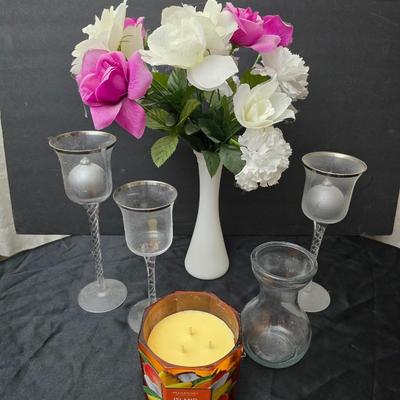 Glass vases and candle holders with boquet of faux flowers