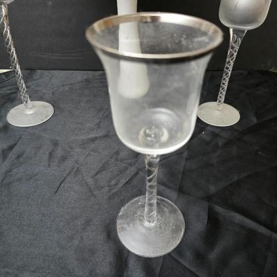 Glass vases and candle holders with boquet of faux flowers