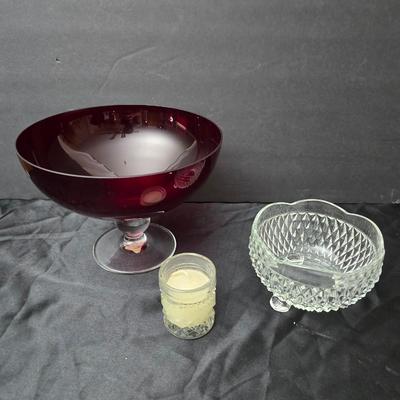 Ruby Red glass grape bowl with a smaller glass bowl and a candle