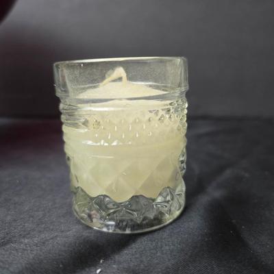 Ruby Red glass grape bowl with a smaller glass bowl and a candle