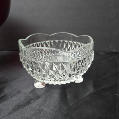 Ruby Red glass grape bowl with a smaller glass bowl and a candle