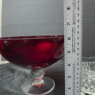 Ruby Red glass grape bowl with a smaller glass bowl and a candle