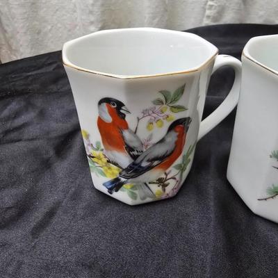 Birdhouse themed metal tea pot with four bird themed mugs - a metal tea pot trivet and a tea strainer