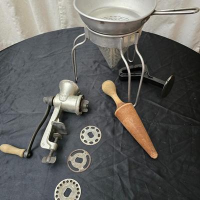 Vintage wearever aluminum strainer with stand and a Boyertown meat grinder with grinding discs