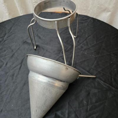 Vintage wearever aluminum strainer with stand and a Boyertown meat grinder with grinding discs
