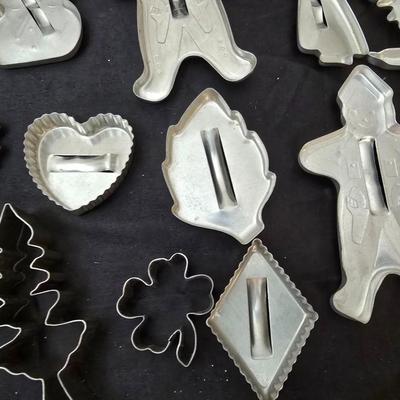 Cookies anyone? Cookie sheet with a large variety of vintage cookie cutters and a Mirror cookie press and copper Jello molds