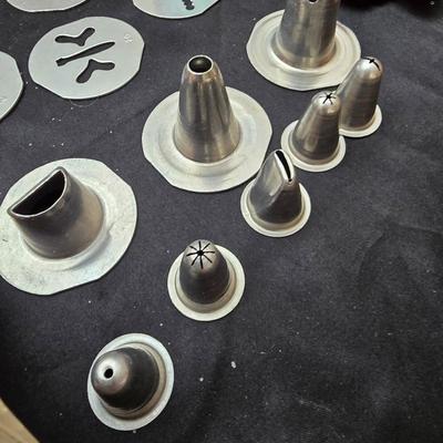 Cookies anyone? Cookie sheet with a large variety of vintage cookie cutters and a Mirror cookie press and copper Jello molds