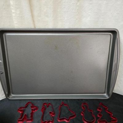 Cookies anyone? Cookie sheet with a large variety of vintage cookie cutters and a Mirror cookie press and copper Jello molds