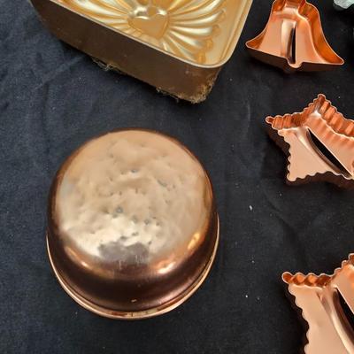 Cookies anyone? Cookie sheet with a large variety of vintage cookie cutters and a Mirror cookie press and copper Jello molds