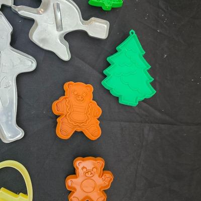 Cookies anyone? Cookie sheet with a large variety of vintage cookie cutters and a Mirror cookie press and copper Jello molds
