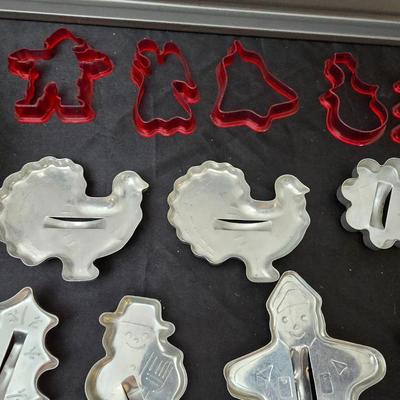 Cookies anyone? Cookie sheet with a large variety of vintage cookie cutters and a Mirror cookie press and copper Jello molds