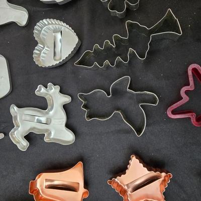 Cookies anyone? Cookie sheet with a large variety of vintage cookie cutters and a Mirror cookie press and copper Jello molds