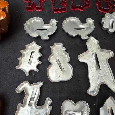 Cookies anyone? Cookie sheet with a large variety of vintage cookie cutters and a Mirror cookie press and copper Jello molds
