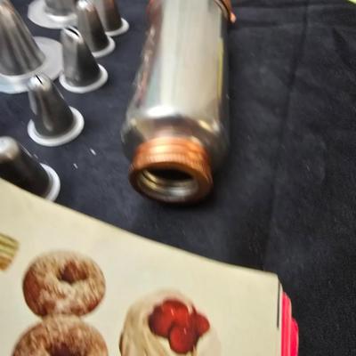 Cookies anyone? Cookie sheet with a large variety of vintage cookie cutters and a Mirror cookie press and copper Jello molds