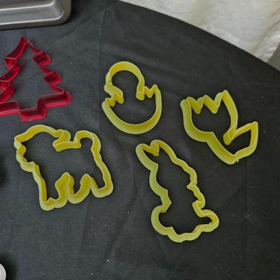Cookies anyone? Cookie sheet with a large variety of vintage cookie cutters and a Mirror cookie press and copper Jello molds