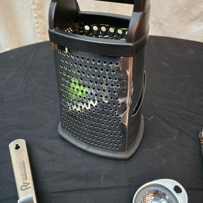 Variet of kitchen gadgets - potato peeler - graters - jar opener and more