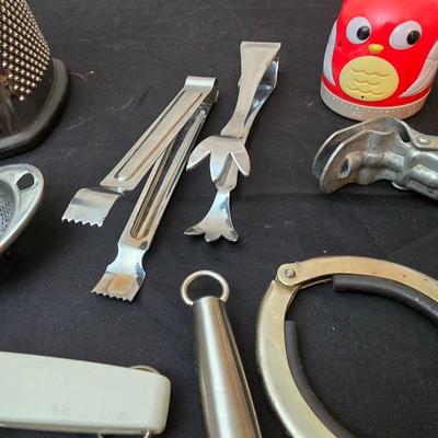 Variet of kitchen gadgets - potato peeler - graters - jar opener and more