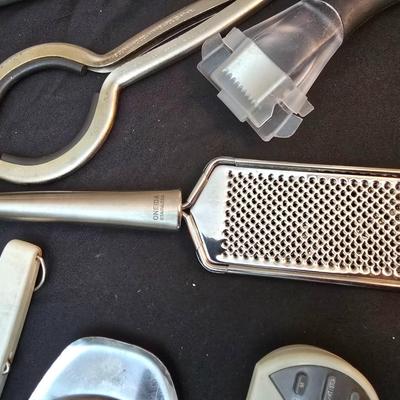 Variet of kitchen gadgets - potato peeler - graters - jar opener and more