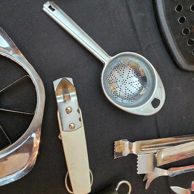 Variet of kitchen gadgets - potato peeler - graters - jar opener and more
