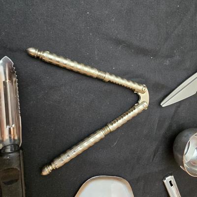 Variet of kitchen gadgets - potato peeler - graters - jar opener and more