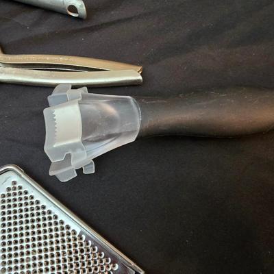 Variet of kitchen gadgets - potato peeler - graters - jar opener and more