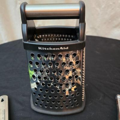 Variet of kitchen gadgets - potato peeler - graters - jar opener and more