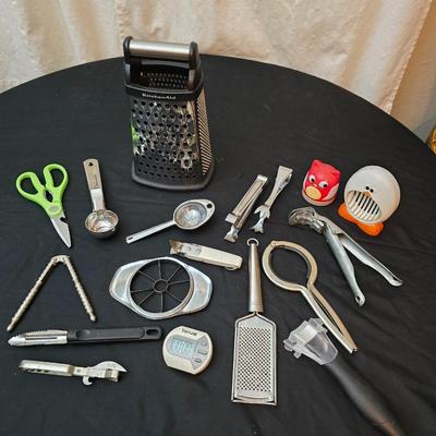 Variet of kitchen gadgets - potato peeler - graters - jar opener and more