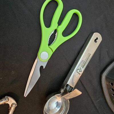 Variet of kitchen gadgets - potato peeler - graters - jar opener and more