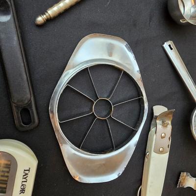 Variet of kitchen gadgets - potato peeler - graters - jar opener and more