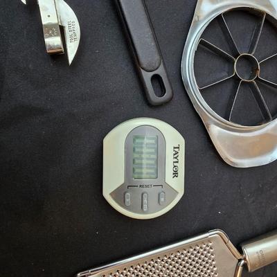 Variet of kitchen gadgets - potato peeler - graters - jar opener and more