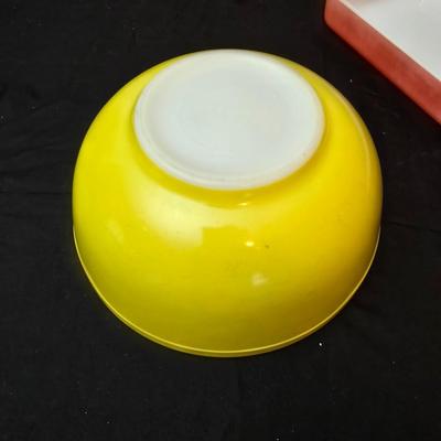 Large yellow pyrex mixing bowl with pink Pyrex cake dish