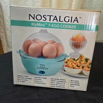 Plastic food storage containers with a Rapid Mac cooker - Nostalgia mini 7 egg cooker - a tiered serving tray and a new knife