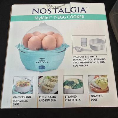 Plastic food storage containers with a Rapid Mac cooker - Nostalgia mini 7 egg cooker - a tiered serving tray and a new knife