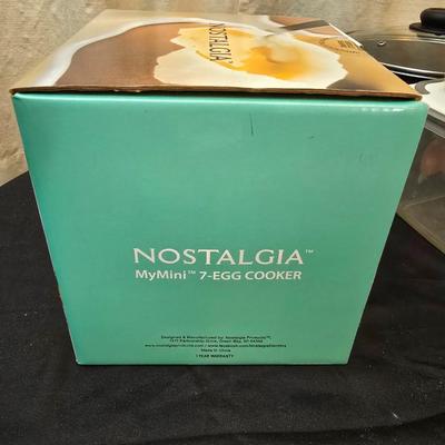 Plastic food storage containers with a Rapid Mac cooker - Nostalgia mini 7 egg cooker - a tiered serving tray and a new knife
