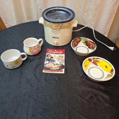 Crockpot with Campbells soup bowl, Ziggy soup bowl, and two hand painted bowls and a Campbells cookbook