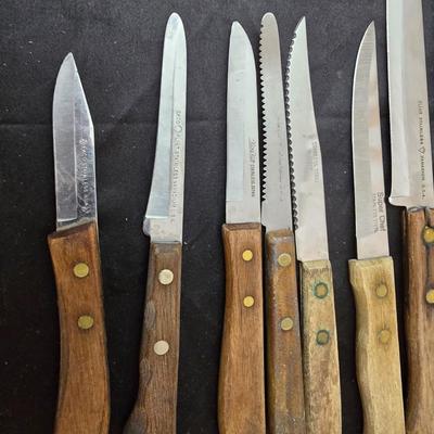 Collection of Kitchen knives, cutting boards, and an electric knife sharppener