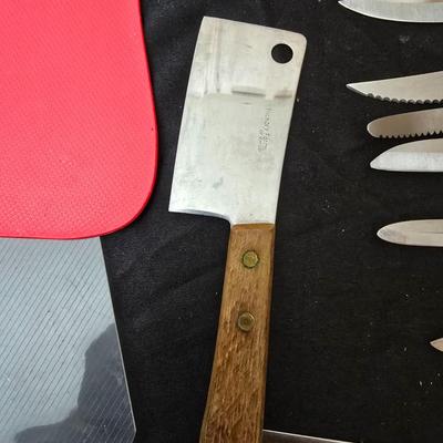 Collection of Kitchen knives, cutting boards, and an electric knife sharppener