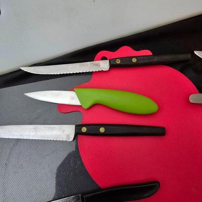 Collection of Kitchen knives, cutting boards, and an electric knife sharppener