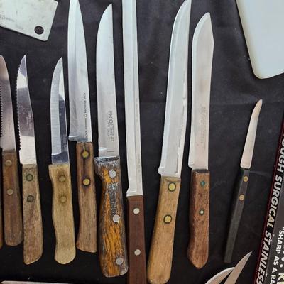 Collection of Kitchen knives, cutting boards, and an electric knife sharppener