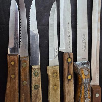 Collection of Kitchen knives, cutting boards, and an electric knife sharppener