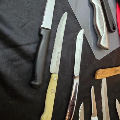Collection of Kitchen knives, cutting boards, and an electric knife sharppener