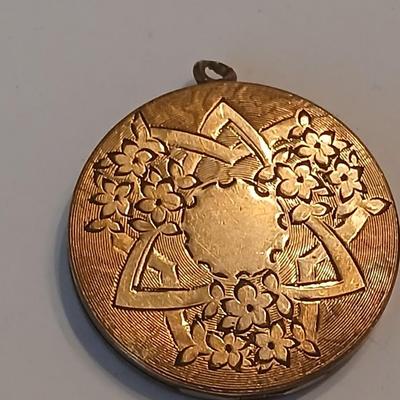 Three gold toned lockets