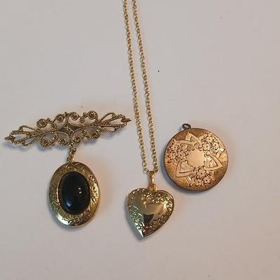 Three gold toned lockets