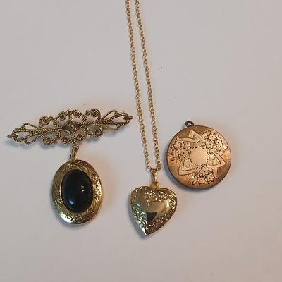 Three gold toned lockets