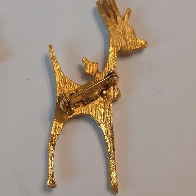 Two vintage reindeer pins with gemstones