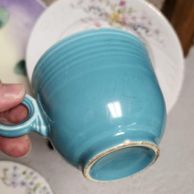 Sale Photo Thumbnail #251: Misc porcelain and stoneware clean up lot. The small plate is metal. Gorgeous hand painted pieces and an odd Fiesta harlequin cup.